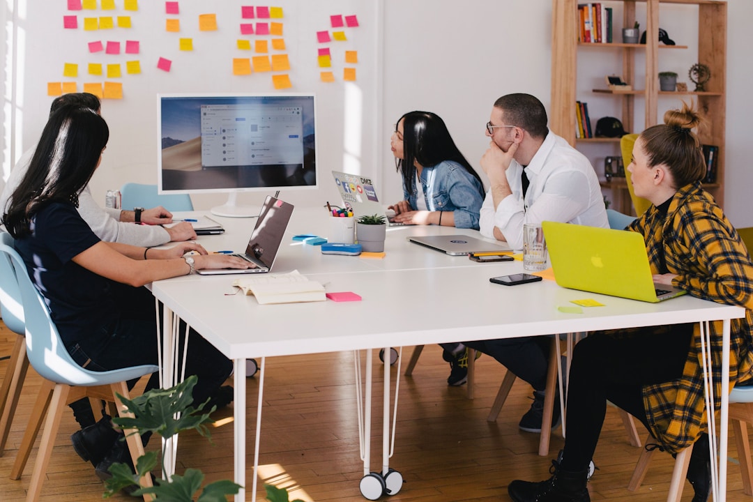 A team in an office discussing fax APIs during a meeting